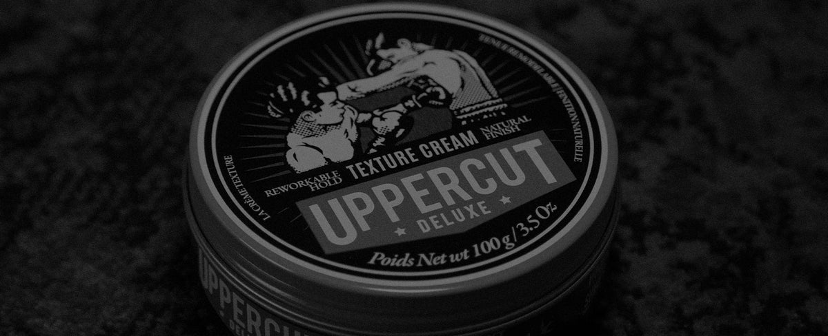 Uppercut Deluxe Texture Cream sitting on a rug
